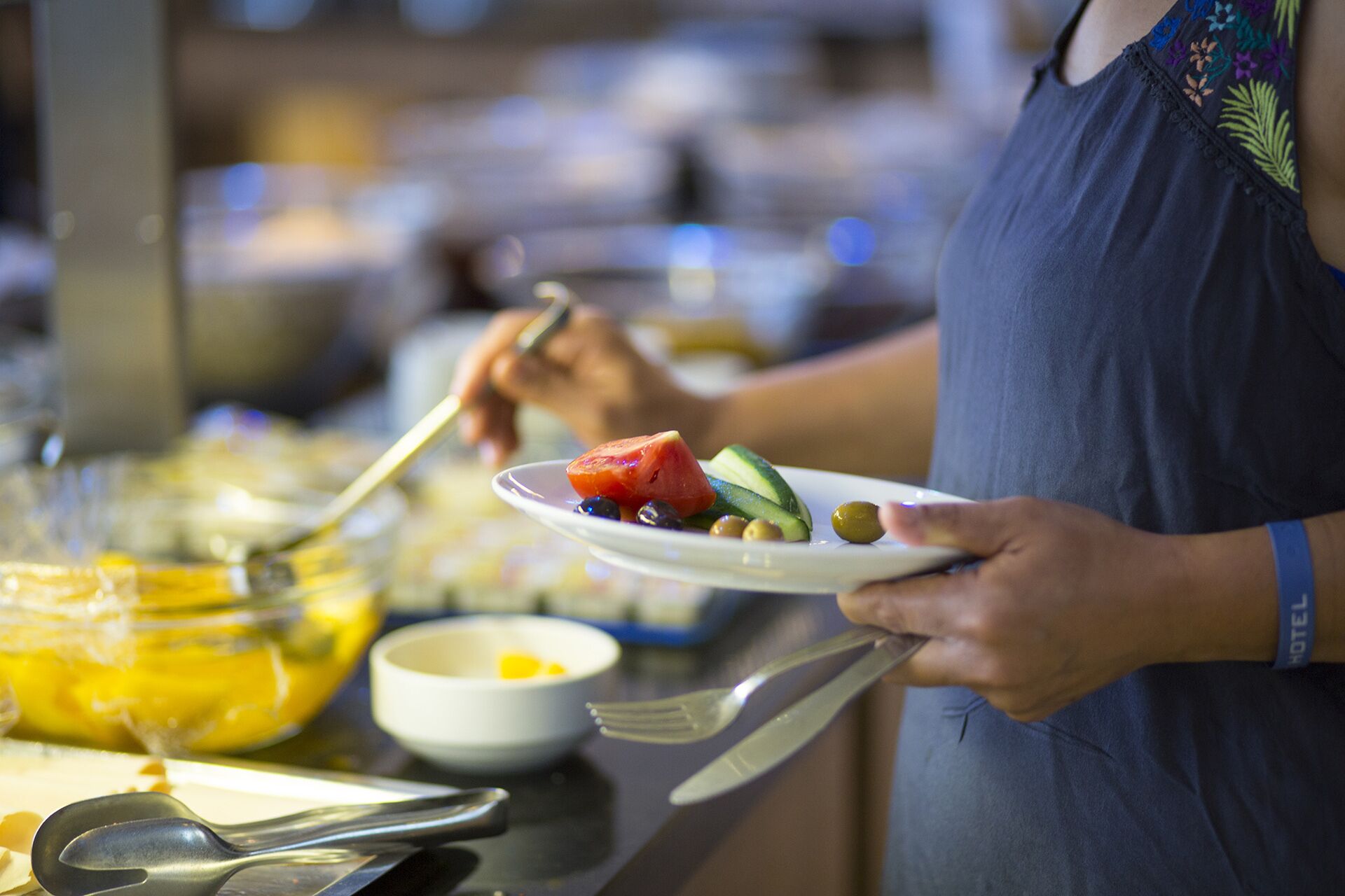 A buffet setup with various food items and utensils.