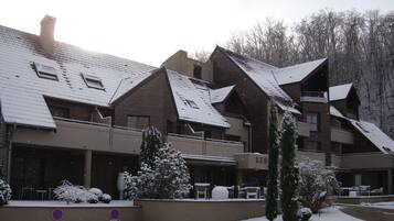 A multi-story hotel with a snow-covered roof and exterior.