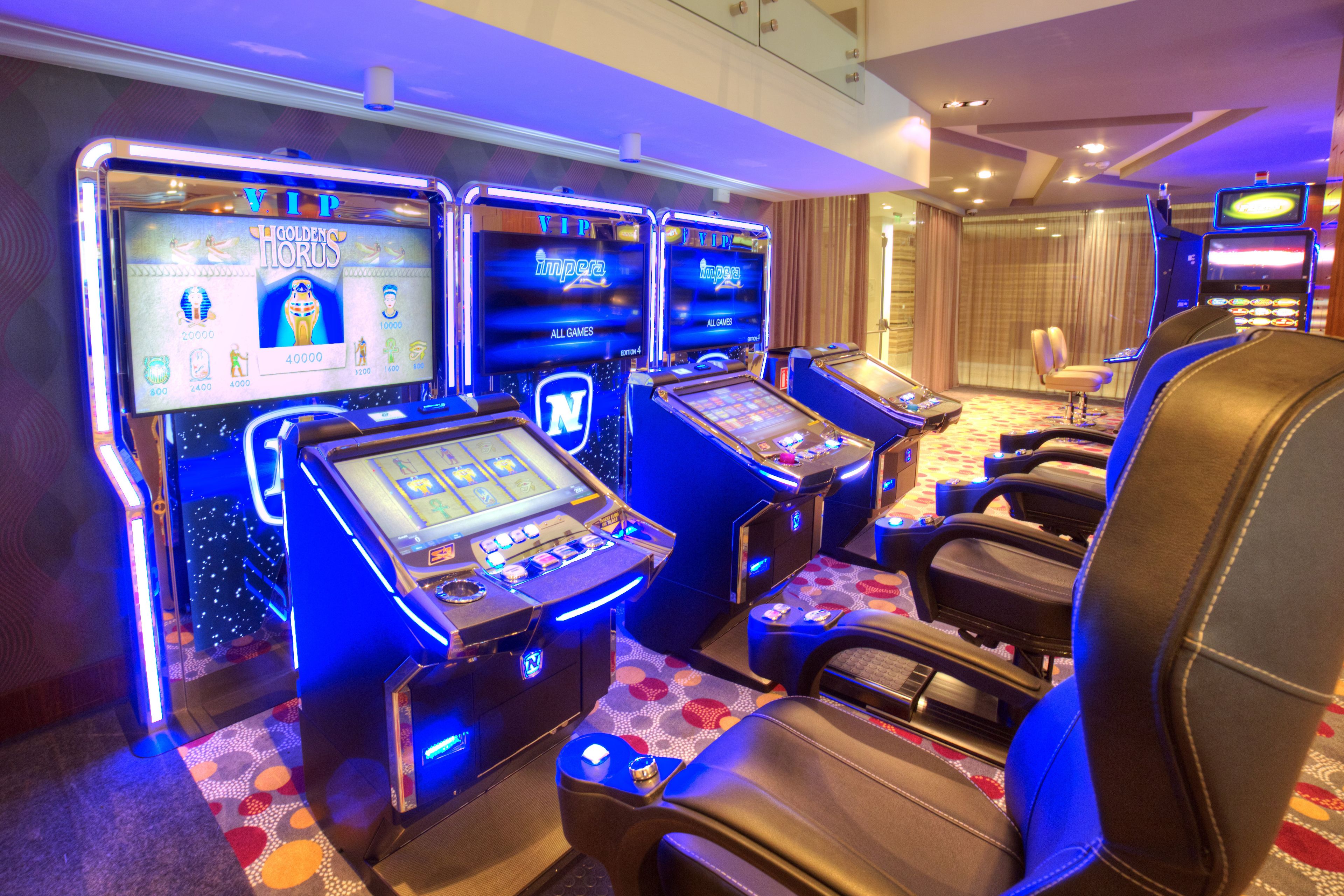 A gaming area with slot machines and comfortable seating.