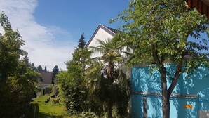 A residential area with a house, lush greenery, and a clear blue sky. - StayInCologne (Cologne)