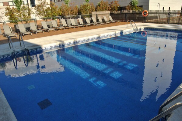Seasonal outdoor pool, open 1:00 PM to 9:00 PM, pool umbrellas