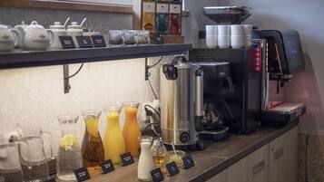 A coffee station with various brewing equipment and labeled drink options.