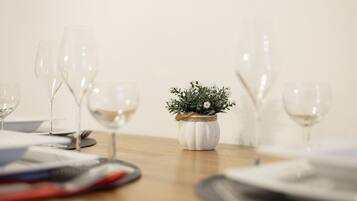 A table with wine glasses and a small potted plant.