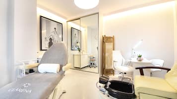 Relax in a serene space with a comfortable reclining chair, bedside table, and large mirror.