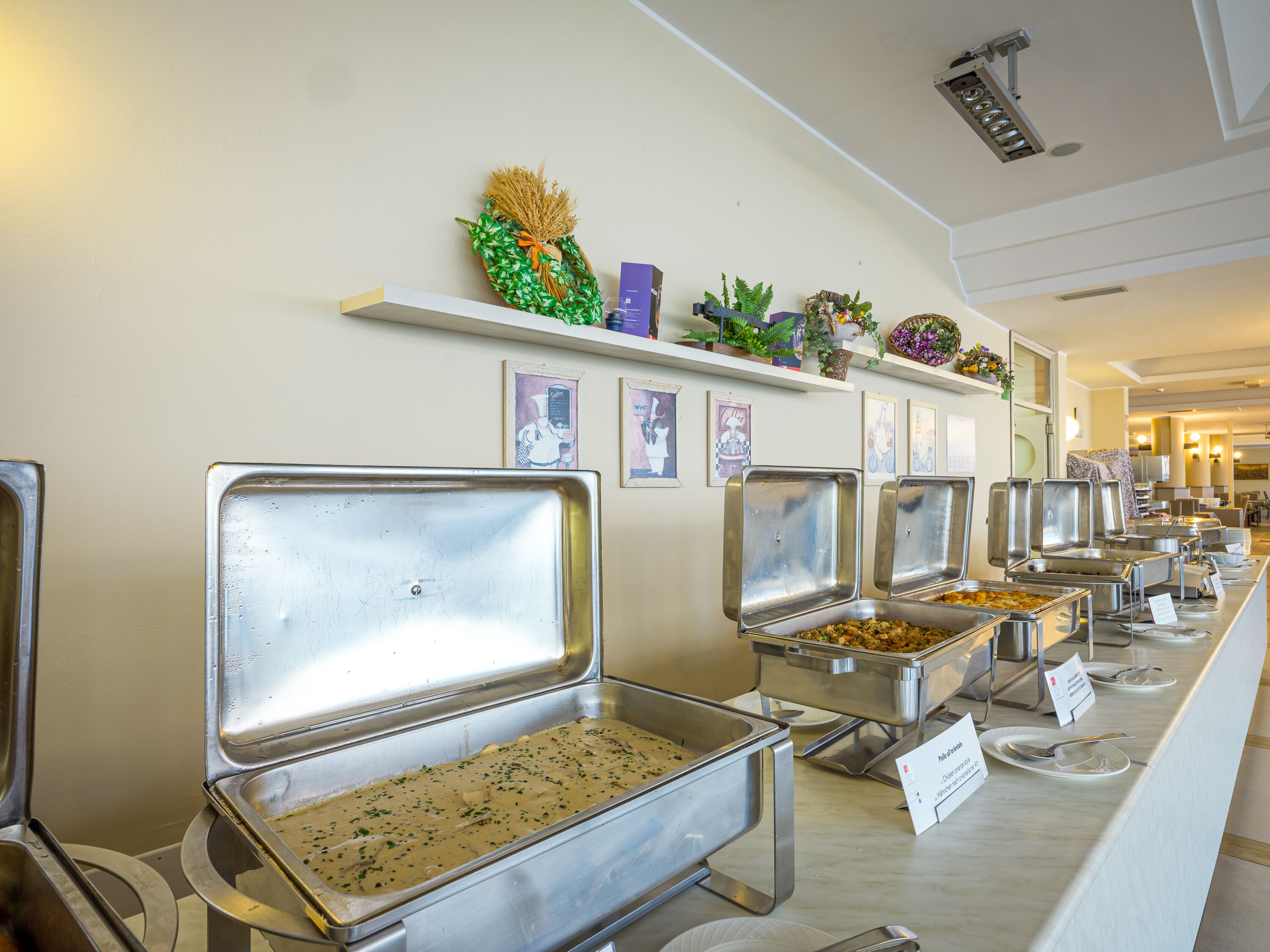 A buffet setup with multiple serving trays and a variety of food items.