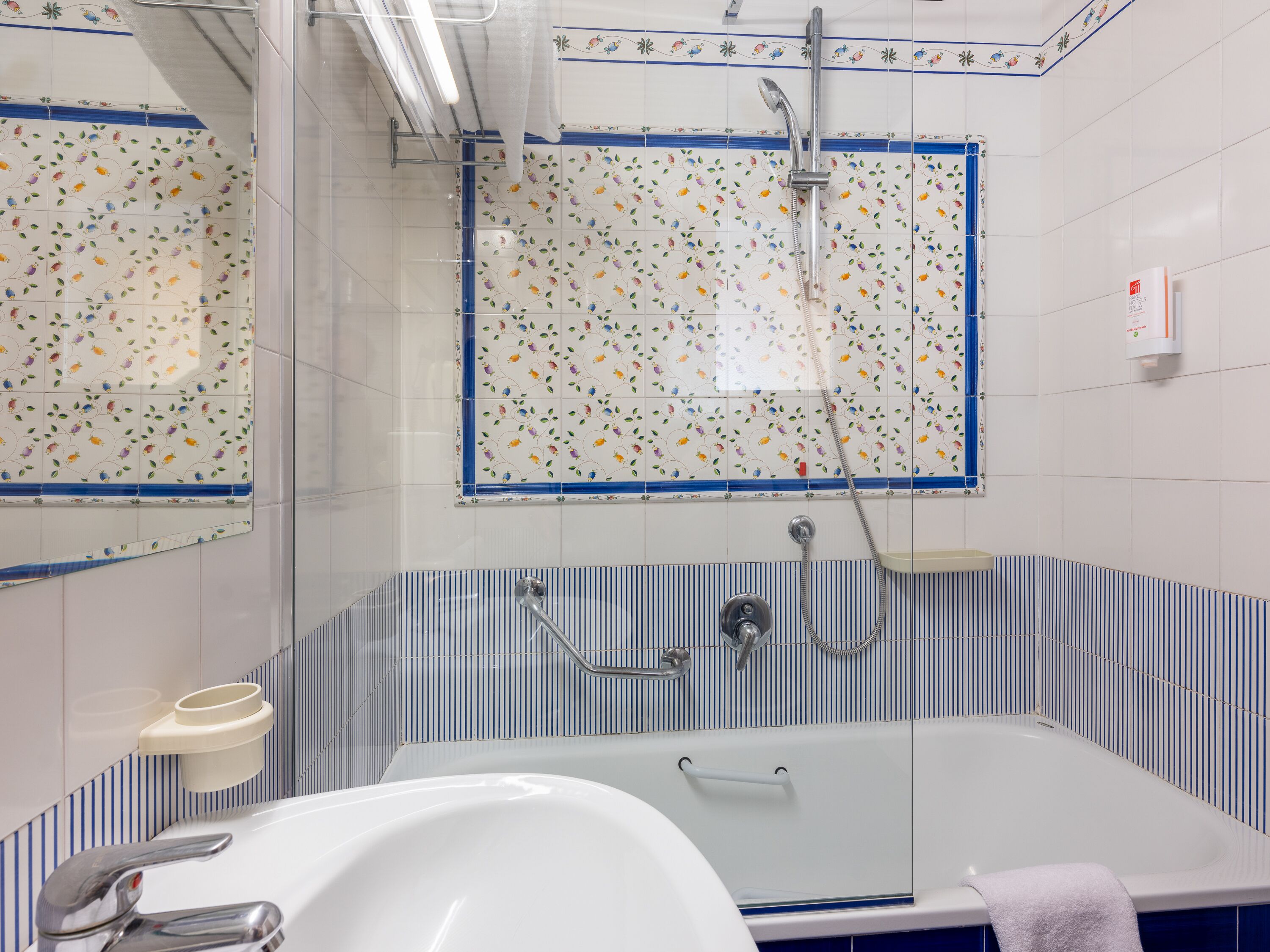 A bathroom with a bathtub, a shower, and a sink.