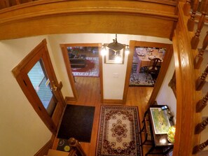 A staircase with wooden railings and a chandelier.