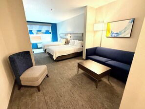 A hotel room with two beds, a blue sofa, a small table, and a chair. - Holiday Inn Express Hotel & Suites NORTH SEQUIM by IHG (Sequim)