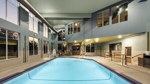 A large indoor swimming pool with a clear view of the pool area, adjacent rooms, and a staircase leading to an upper level. - Holiday Inn Express Hotel & Suites NORTH SEQUIM by IHG (Sequim)