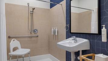 Room, 1 King Bed, Accessible (Mobility & Hearing, Roll-in Shower) | Bathroom | Combined shower/tub, free toiletries, hair dryer, towels