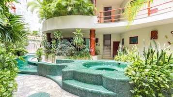 A multi-level indoor garden with a central water feature and tiered seating.