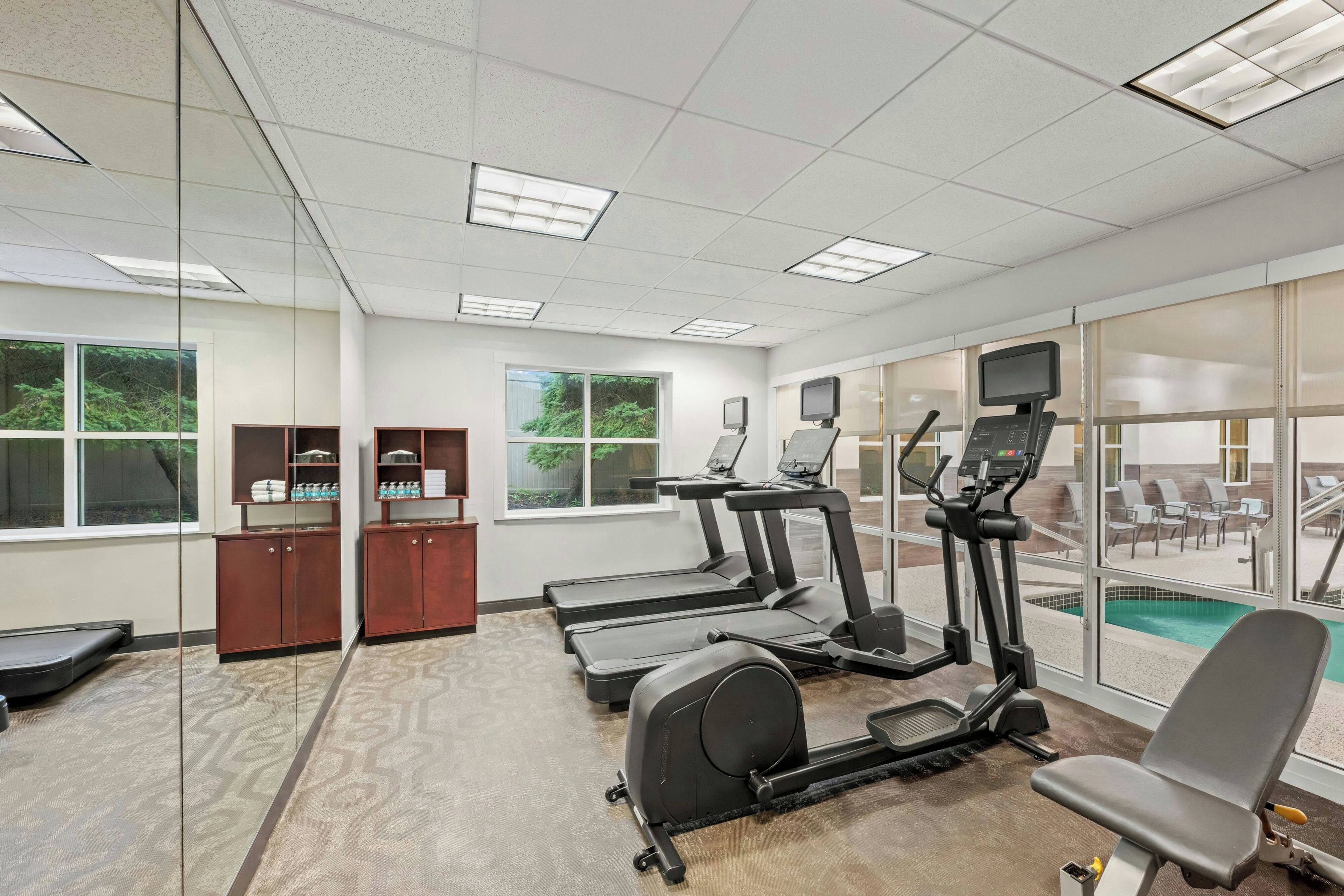 Un centre de remise en forme équipé de tapis de course, d’un vélo d’appartement et d’un appareil d’aviron.