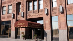 A historic building with a brown awning labeled "The Giacomo Hotel and Residences." - The Giacomo Niagara Falls NY, an Ascend Collection Hotel (Niagara Falls)