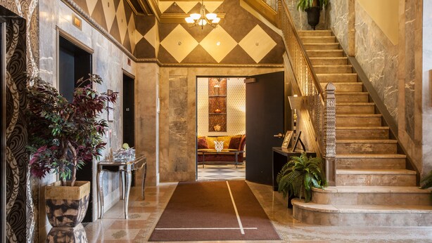 A grand lobby with a marble staircase, a central seating area, and a chandelier. - The Giacomo Niagara Falls NY, an Ascend Collection Hotel (Niagara Falls)
