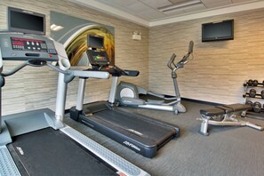 A gym with treadmills, an elliptical, and dumbbells. - Courtyard by Marriott Clarksville (Clarksville)