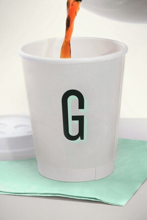 A white cup with a black 'G' logo on it. - Garner Hotel Norman Universirty Area by IHG (Norman)