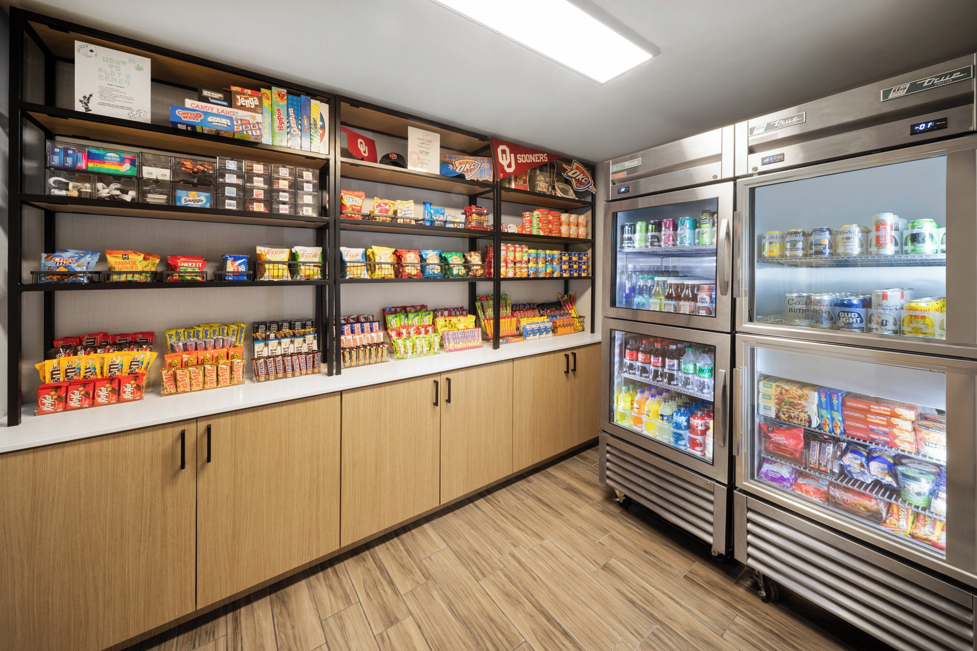 A snack and beverage vending area with multiple shelves stocked with various snacks and drinks.