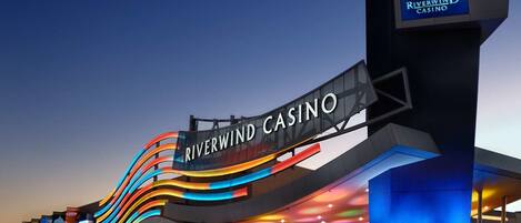 The exterior of Riverwind Casino with a prominent illuminated sign and a modern architectural design.