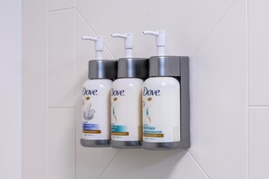 Three Dove personal care products mounted on a wall. - Garner Hotel Norman Universirty Area by IHG (Norman)