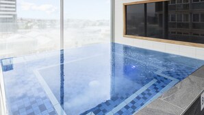A modern indoor pool with a clear view of the cityscape through large windows. - iStay Precinct Adelaide (Adelaide)