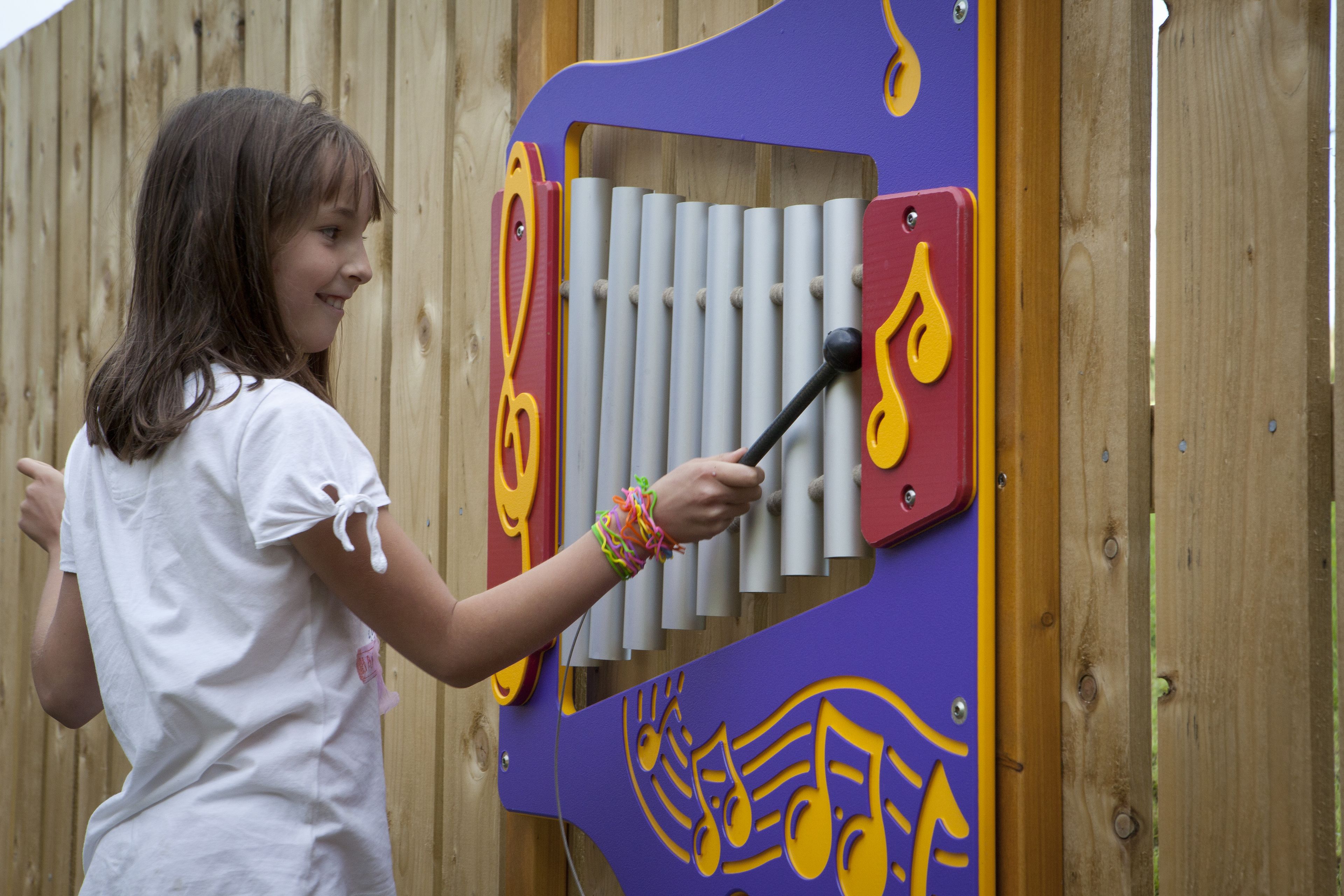 A child playing a musical instrument with a colorful design.