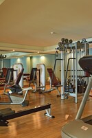 A gym with various exercise equipment, including treadmills and weight machines.