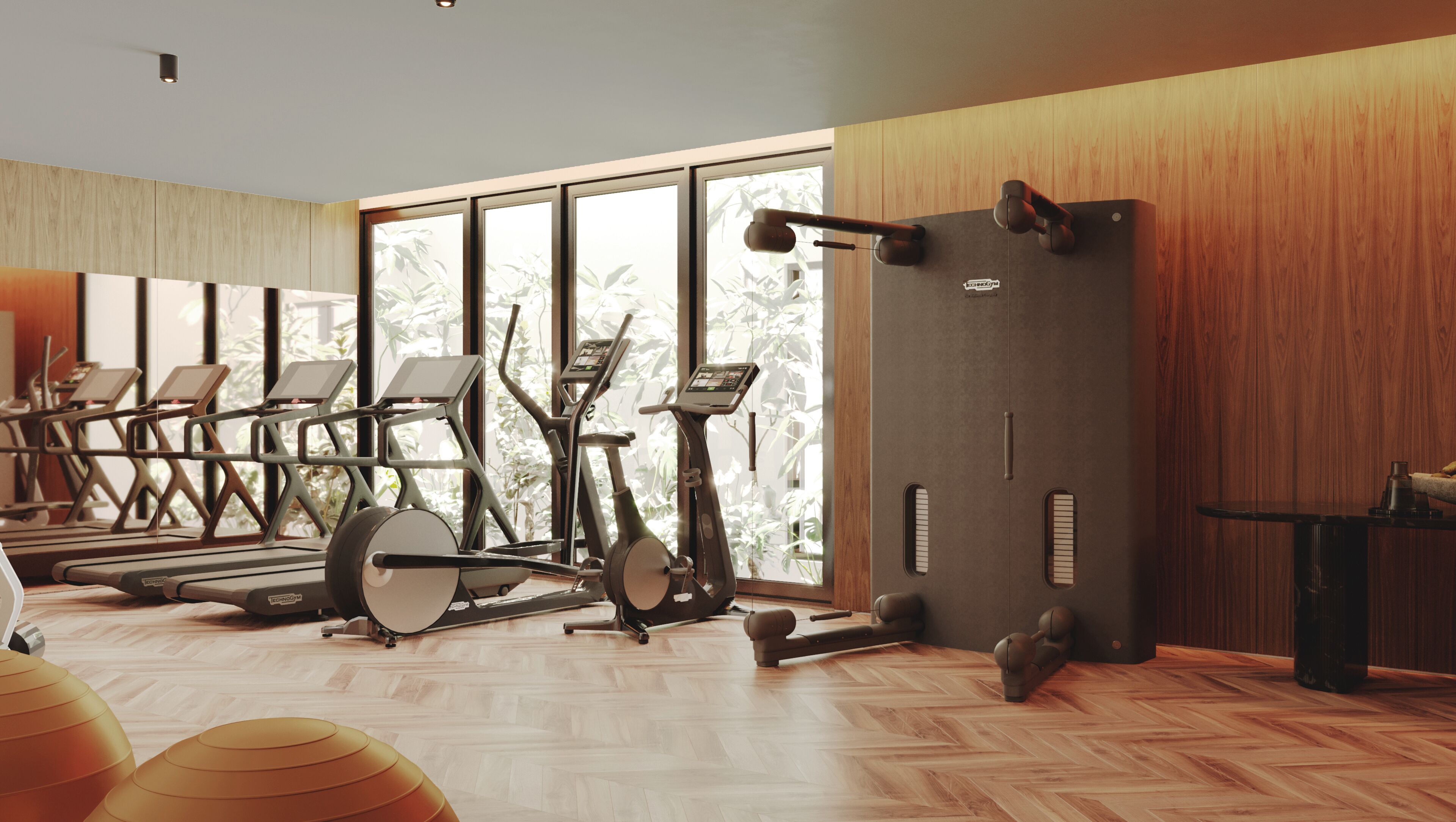 Une salle de sport équipée de matériel d’exercice, dotée de grandes fenêtres et d’un lambris en bois.