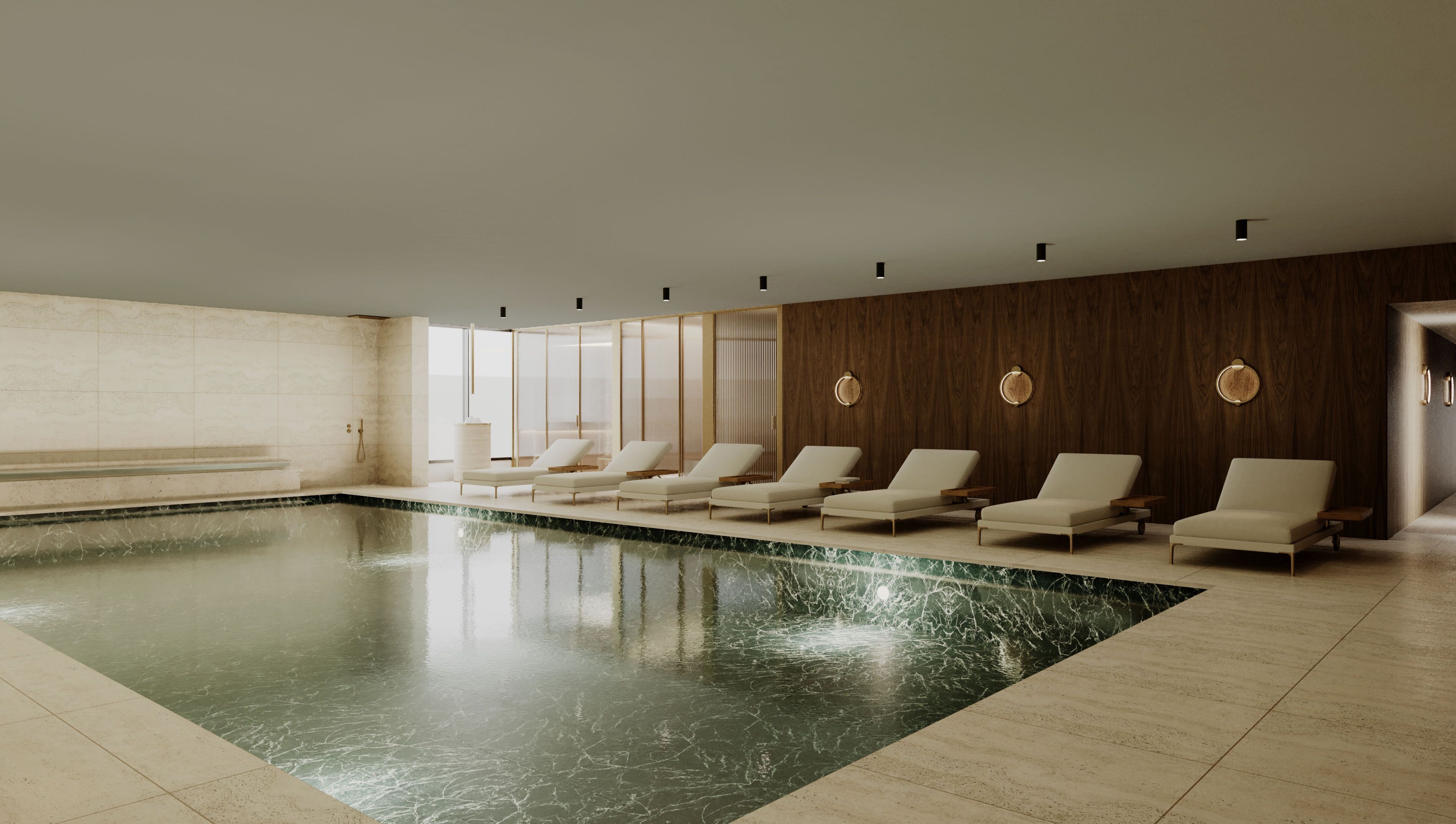 A modern indoor swimming pool with lounge chairs and a wooden wall.
