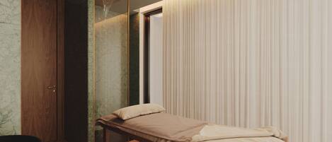 A modern bedroom with a wooden bed, a built-in bench, a wardrobe, and a shower.