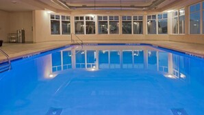 An indoor swimming pool with clear blue water, surrounded by windows and a tiled floor. - Holiday Inn Express Hotel & Suites Bainbridge by IHG (Bainbridge)