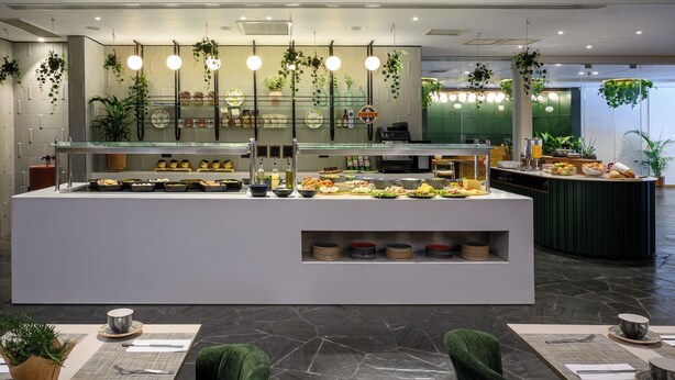 A buffet area with various food options, a coffee station, and hanging plants. - Prima Vera (Jerusalem)
