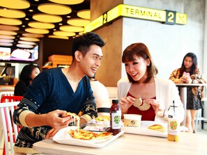 A restaurant with a modern interior, featuring a yellow sign indicating a terminal.