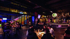A restaurant with a bar area, tables, and chairs. - Resorts World Genting - First World Hotel (Genting Highlands)