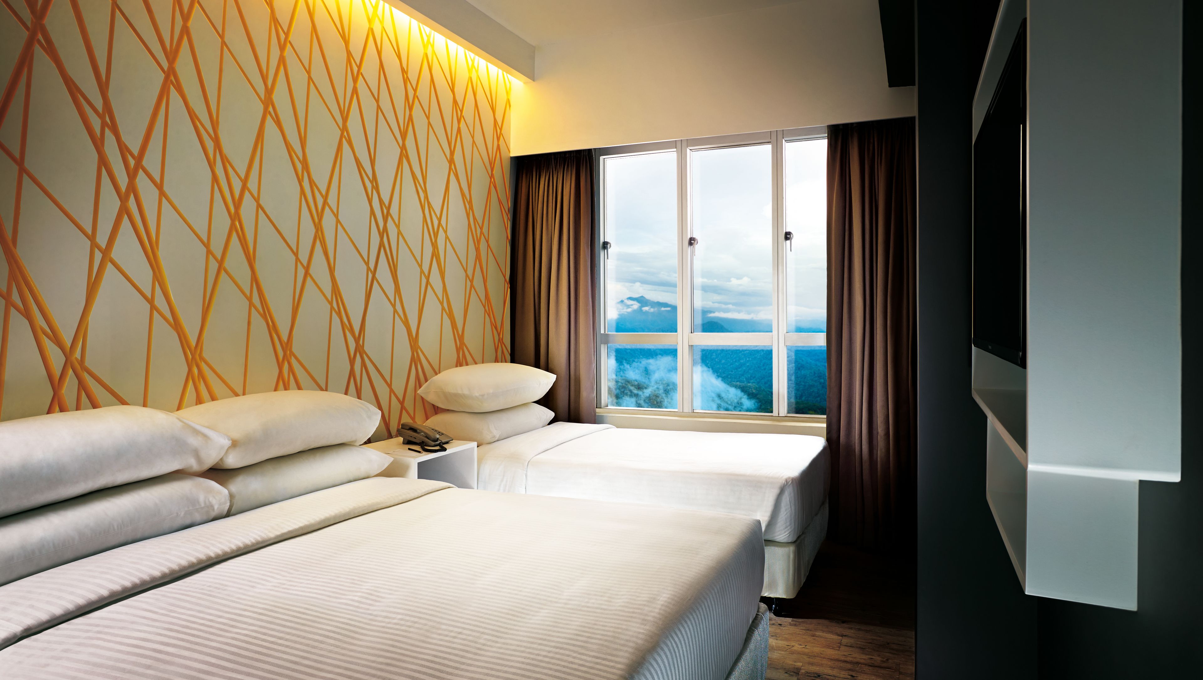 A hotel room with two beds, a large window with a mountain view, and a modern wall design.