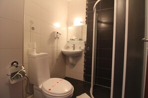 A bathroom with a toilet, sink, and shower. - Mountview Lodge (Bansko)
