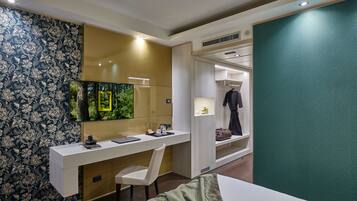 Een moderne hotelkamer met een bureau, stoel en een inloopkast.