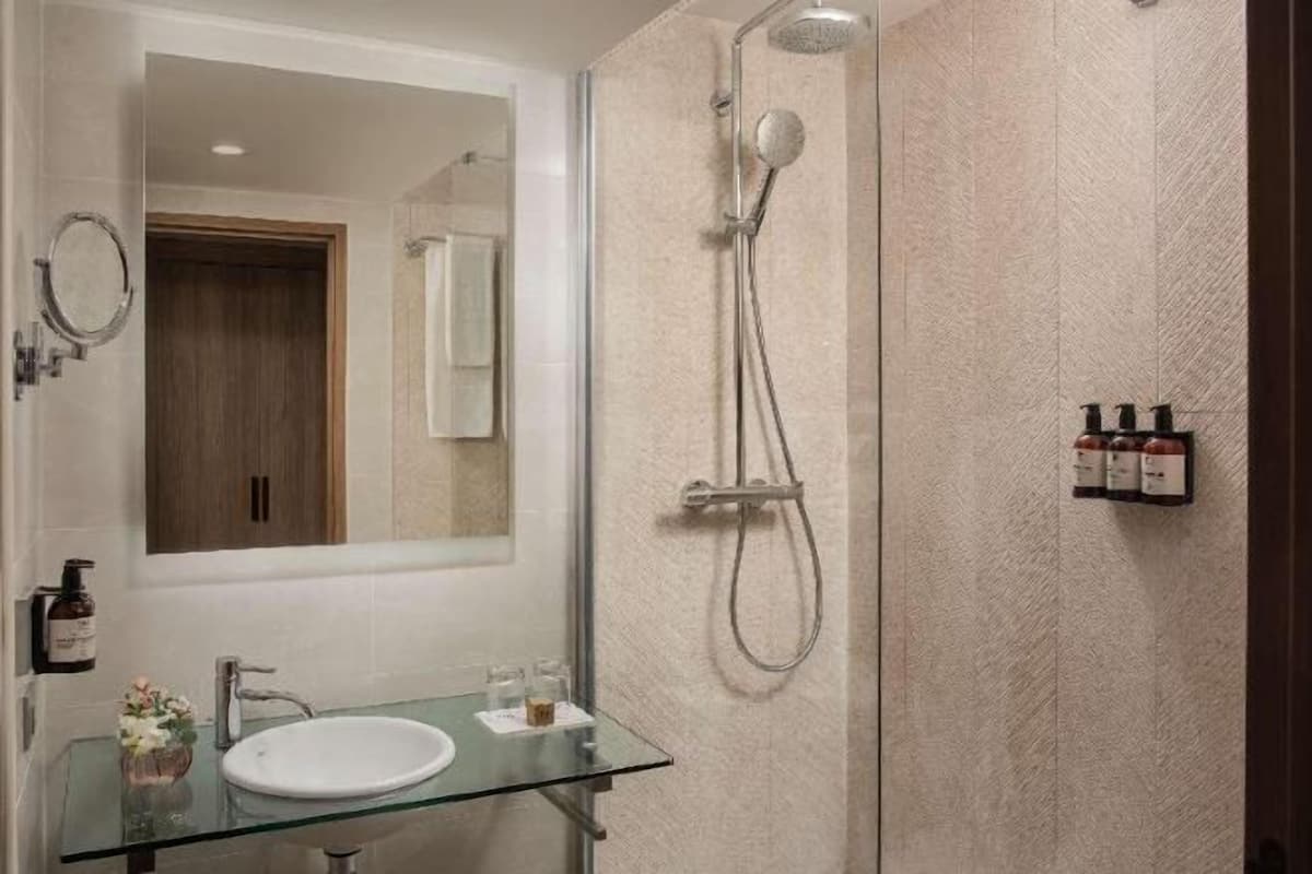 Bathtub, eco-friendly toiletries, hair dryer, towels