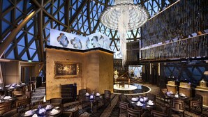 A spacious hotel lobby with a high ceiling, a grand chandelier, and a central seating area. - Grand Lisboa Macau (Macau)