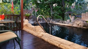 A wooden deck with a stone edge leading to a water feature. - Lavilla By Holiday Villa Cherating (Cherating)