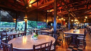 A spacious restaurant with high ceilings and natural light from large windows. Tables are arranged in a casual layout, and the floor features a checkered pattern. - Lavilla By Holiday Villa Cherating (Cherating)