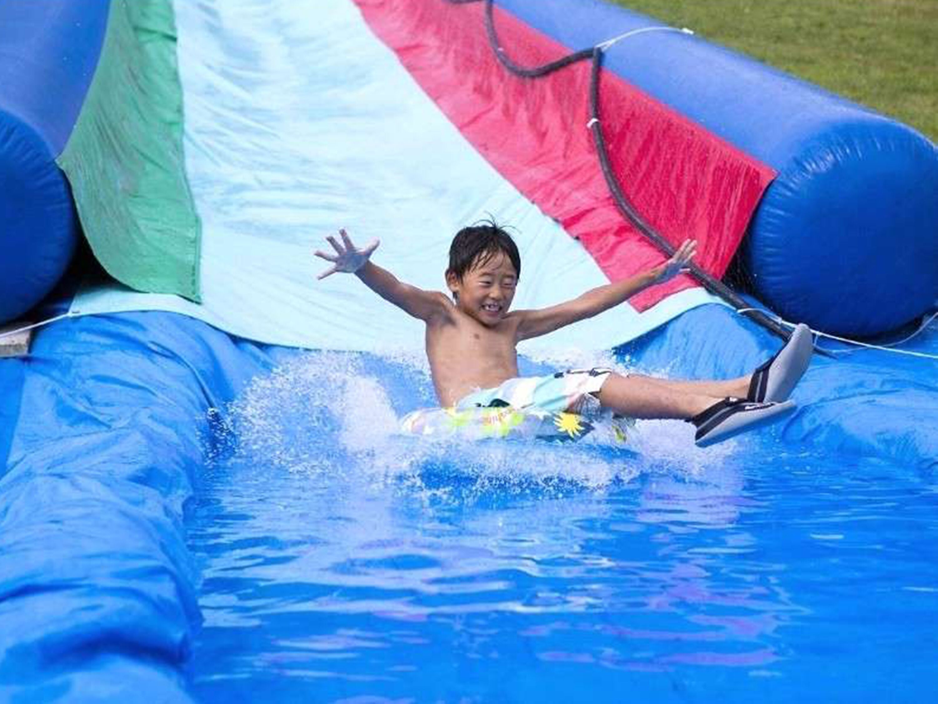 A person in a blue inflatable water slide.