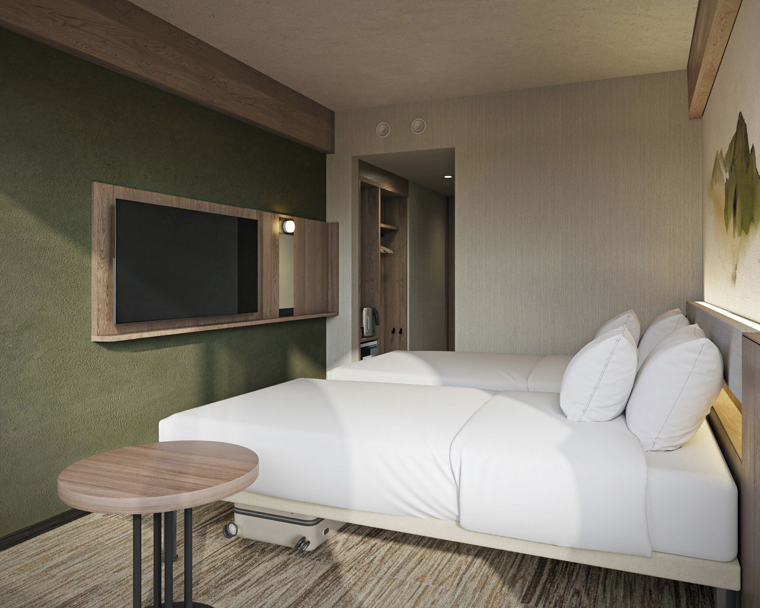 A hotel room with a bed, a small round table, a TV mounted on the wall, and a closet.