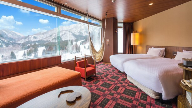 A hotel room with a large window, a bed, a sofa, and a chair. - Naeba Prince Hotel (Yuzawa)