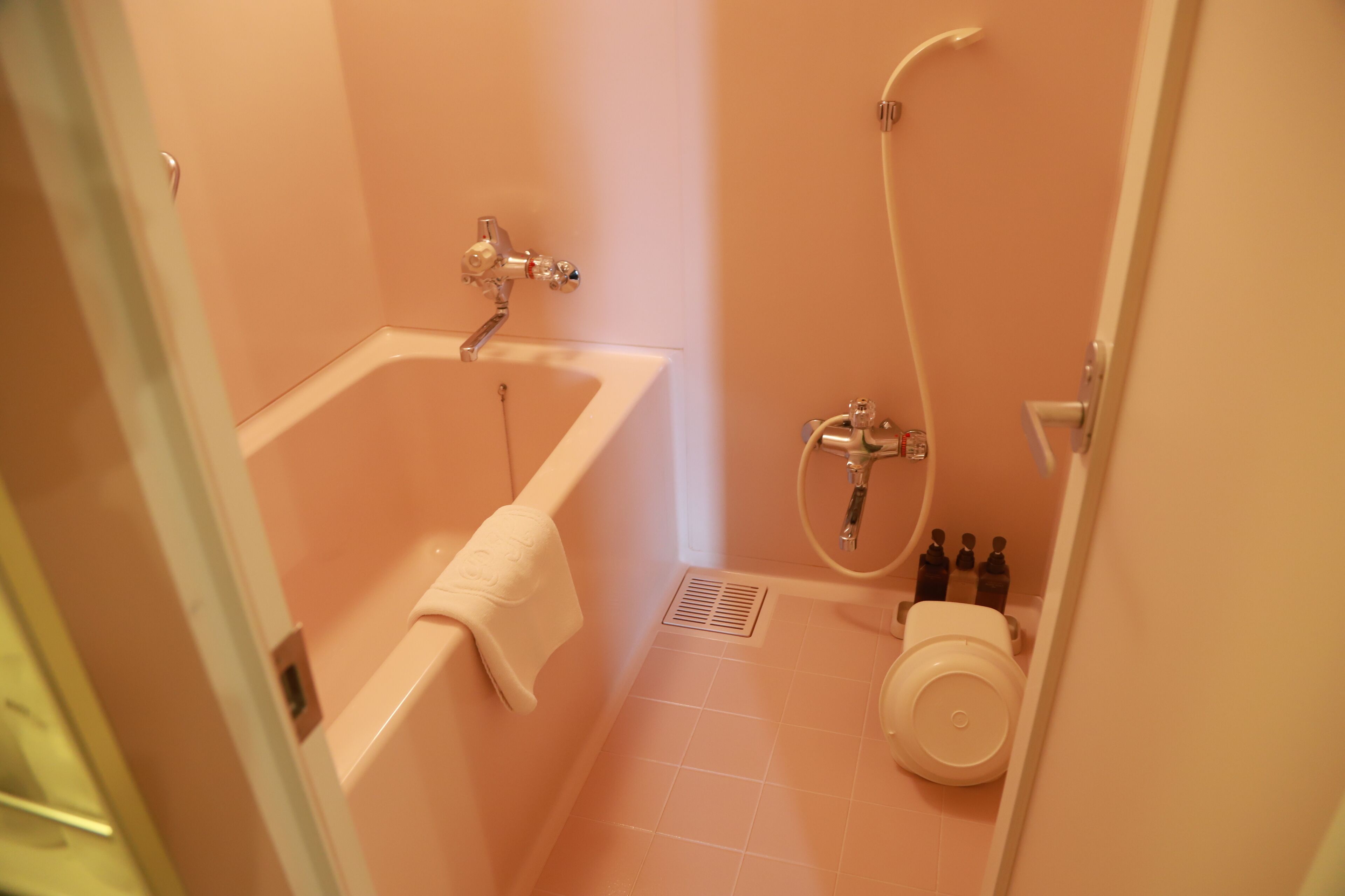 A bathroom with a bathtub, toilet, and shower.
