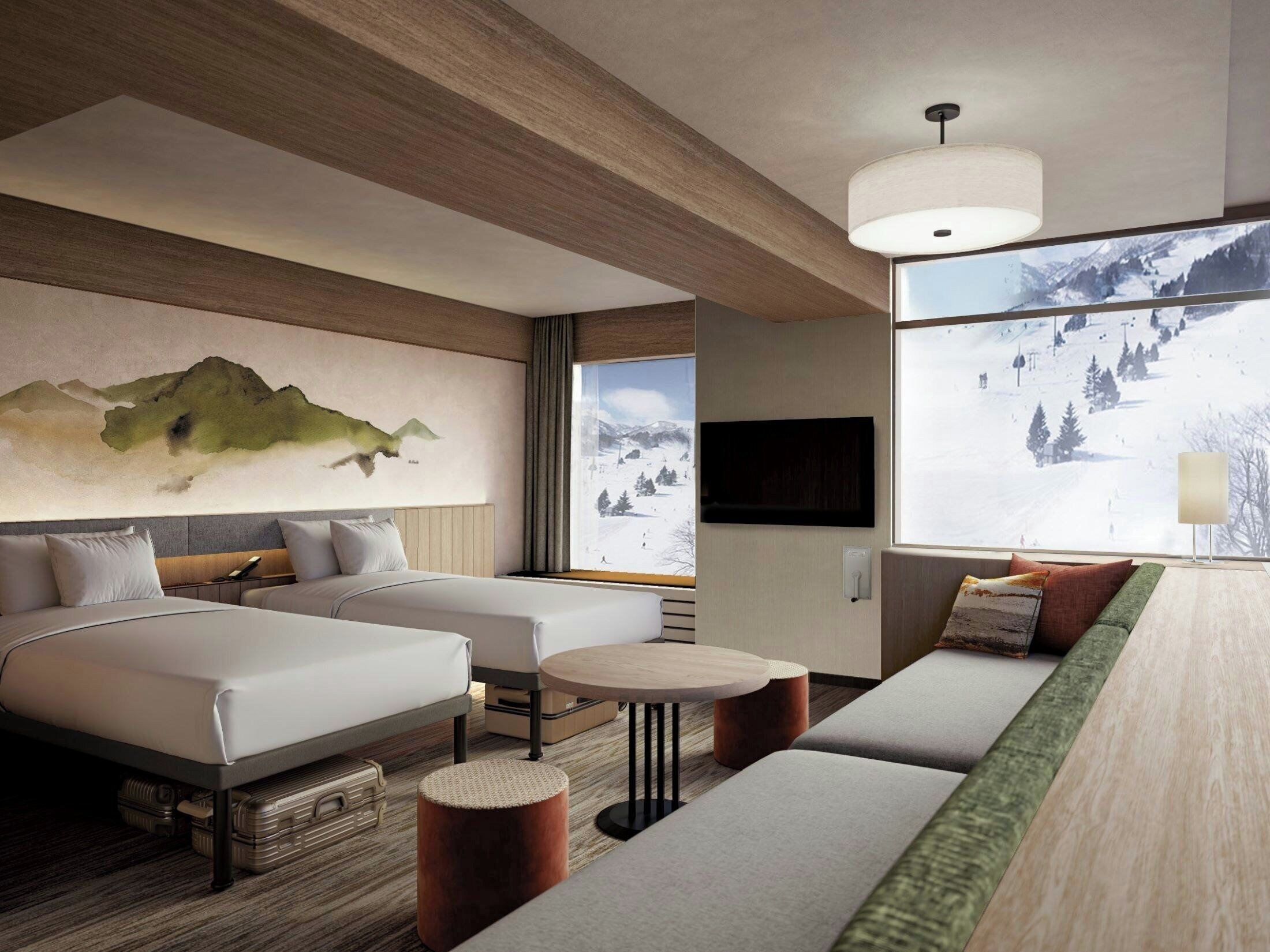 A modern hotel room with a large bed, a sofa, a small table, and a TV.