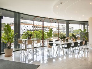 A modern conference room with a large table, chairs, and potted plants. - B&B HOTEL Latina (Latina)