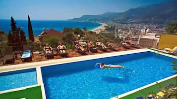 Outdoor pool, open 8 AM to 7 PM, pool umbrellas, pool loungers