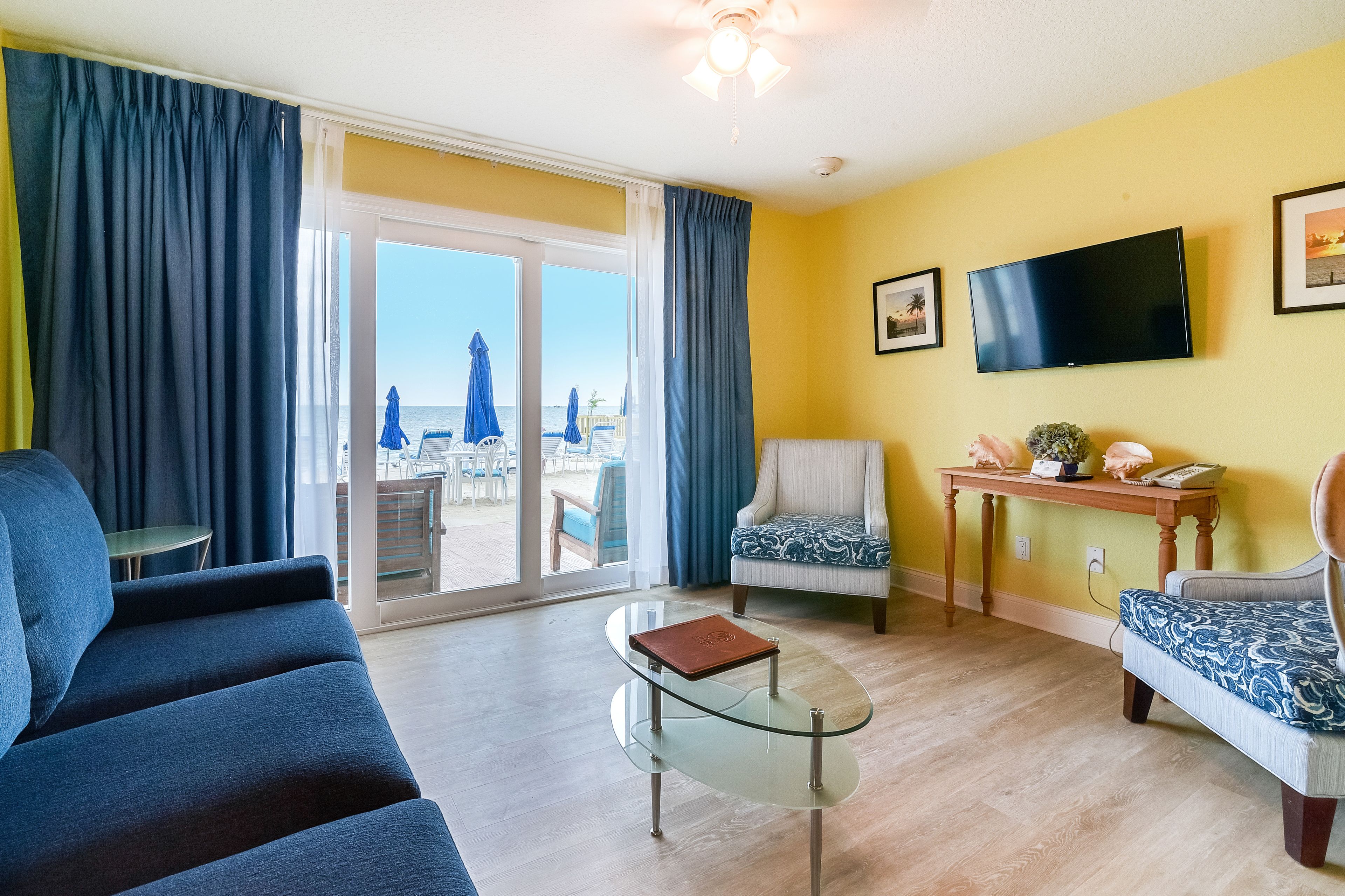 deluxe suite, beachfront | living area | 32-inch tv with cable channels