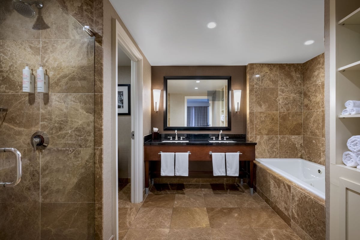 combined shower/bathtub, designer toiletries, hair dryer, bathrobes