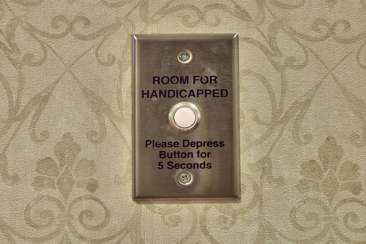 A button labeled 'ROOM FOR HANDICAPPED' with instructions to depress the button for 5 seconds.